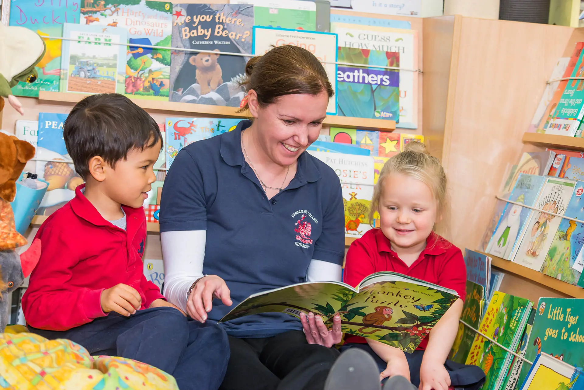 Rendcomb College EYFS teacher and students reading a book