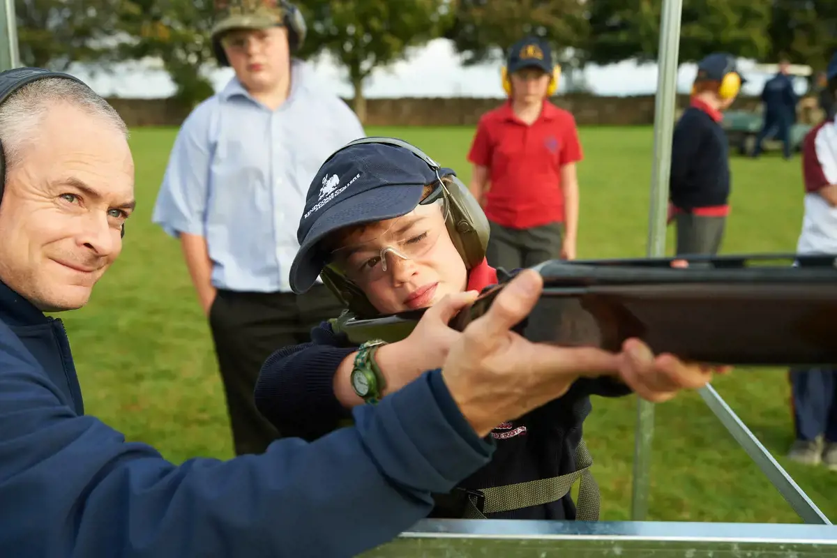 Rendcomb College student aiming a shotgun