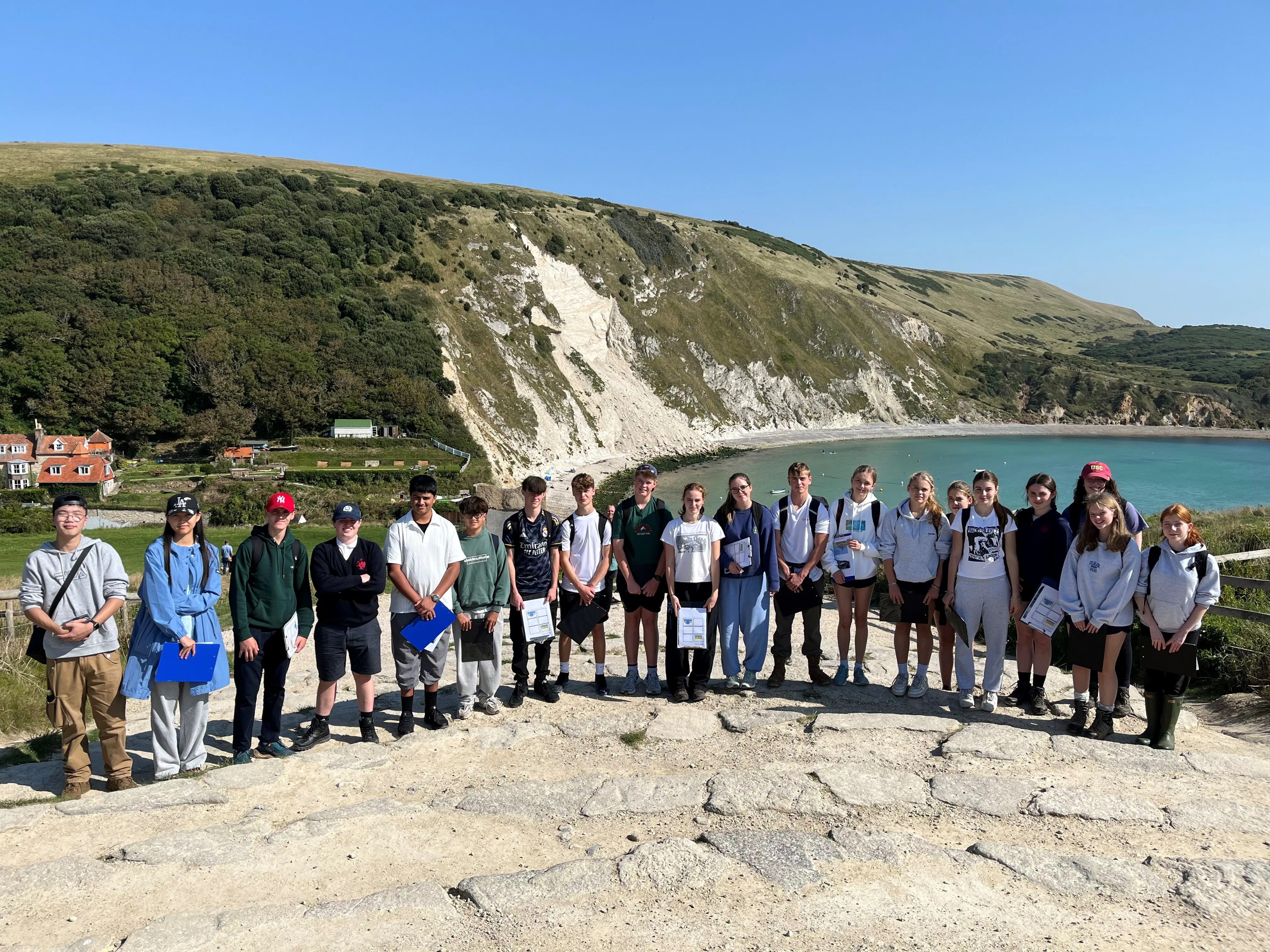 Rendcomb College Year 11 students stood on a cliff by the Jurassic Coast.